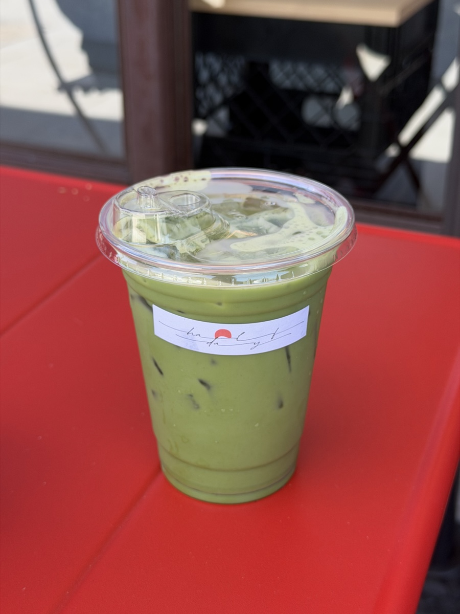 An iced matcha at Halfday on a red café table